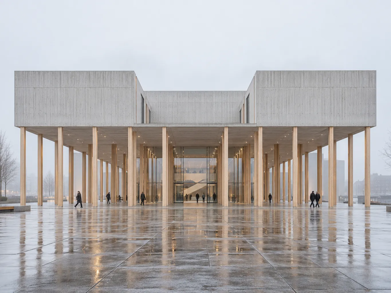 Contemporary Danish cultural centre in pale board-marked concrete with a long colonnade of slender glulam timber…