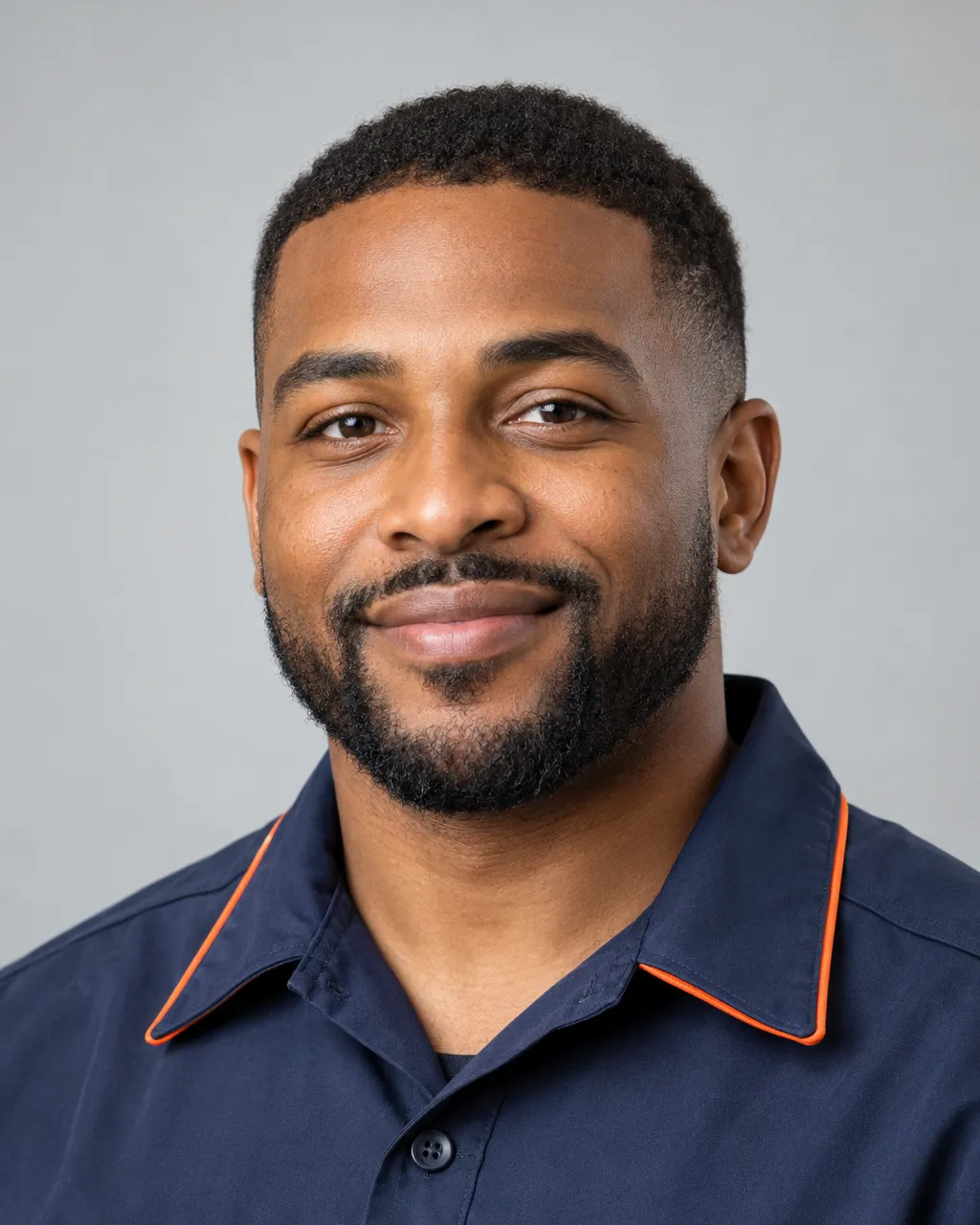 Head-and-shoulders portrait of an African American man in his thirties with a close-cropped beard, emergency…
