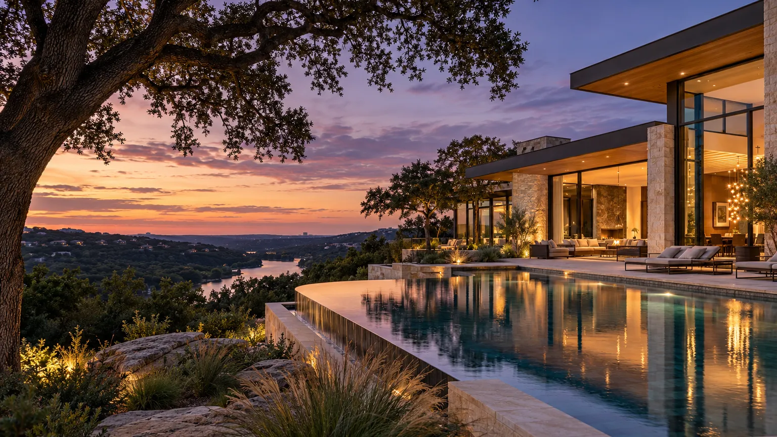 Architectural photograph of a modern limestone and glass hill-country residence in Austin at dusk, floor-to-ceiling…