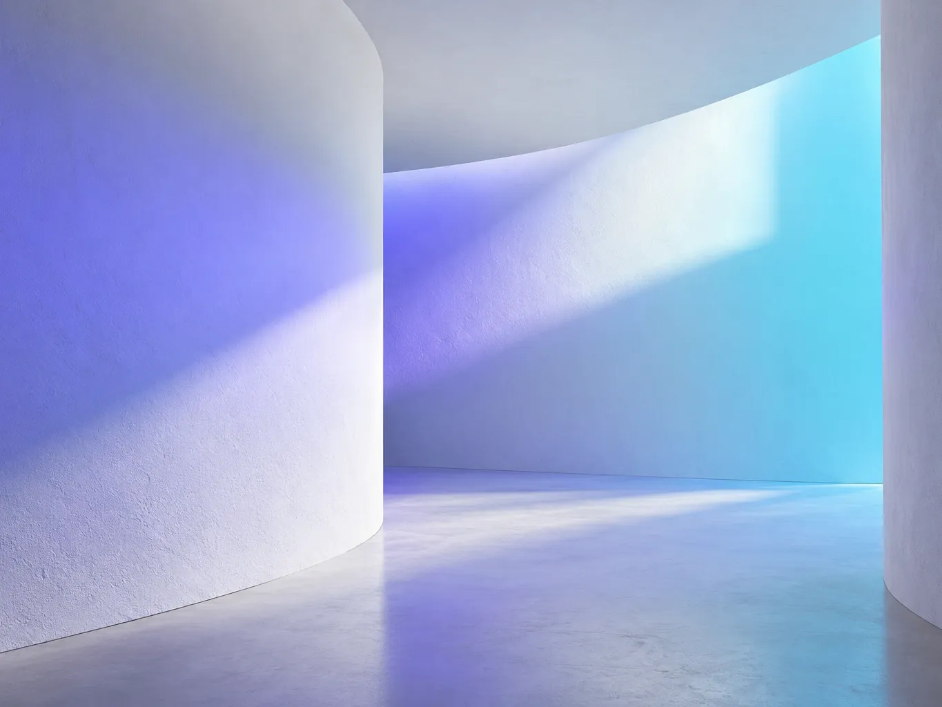 Abstract architectural photograph of soft violet and cyan light falling across curved white plaster walls, gentle…