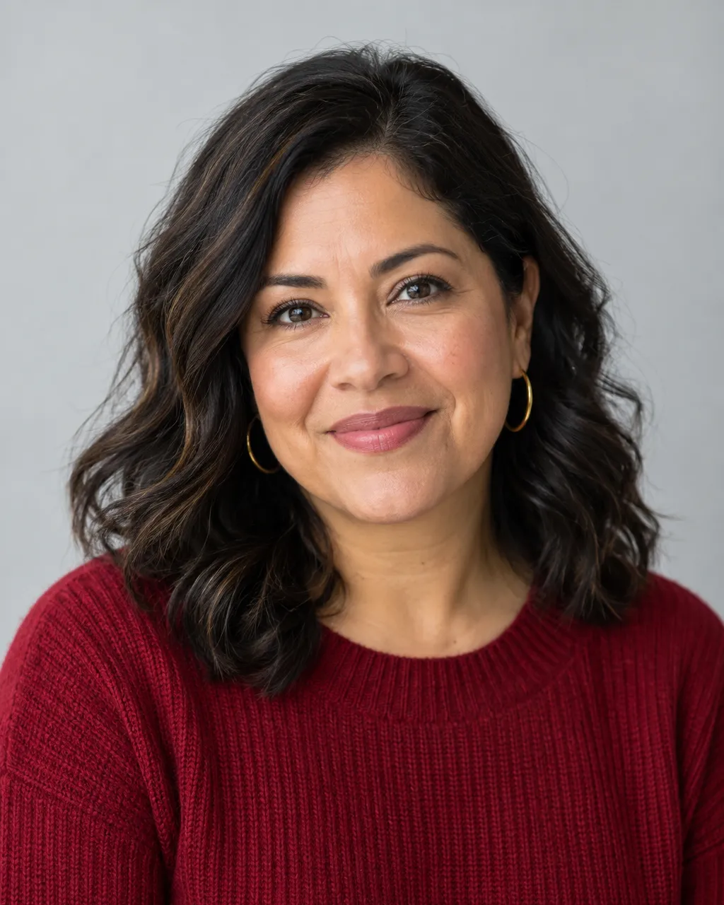 Professional portrait of a Latina woman in her late thirties, middle school director, dark wavy shoulder-length…